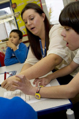 Teacher showing a girl an activity card