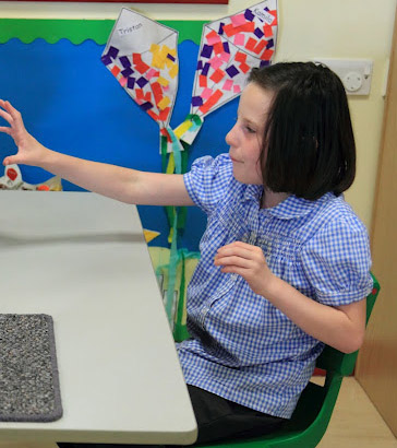 Girl reaching for object.