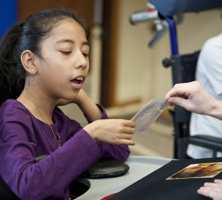 Teacher showing two activity cards to
                  a girl to choose from