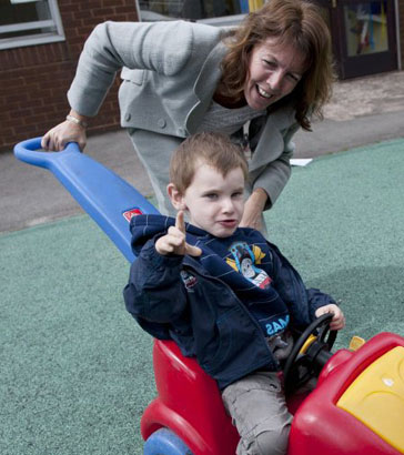 Teacher interacting with a disabled girl