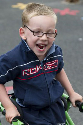 Disabled girl being shown a spinning top