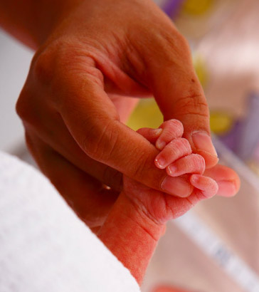 Newborn grasping mother's
finger.