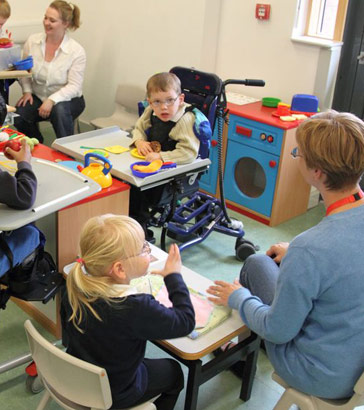 students and children in a classroom