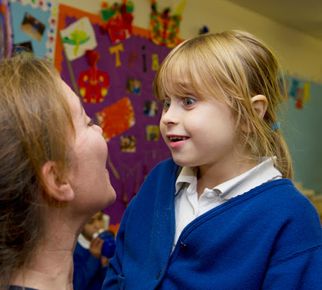 Teacher with a girl looking in
                  each other's eyes