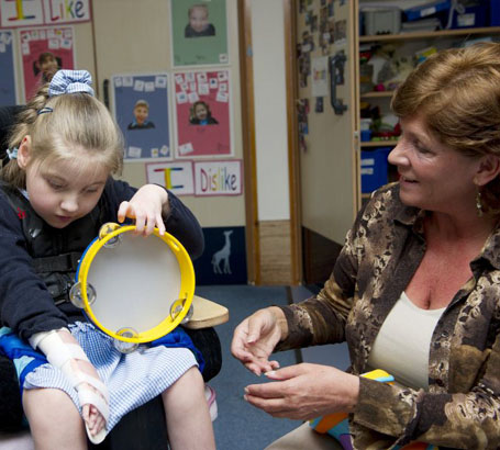 Teacher interacting with a disabled girl