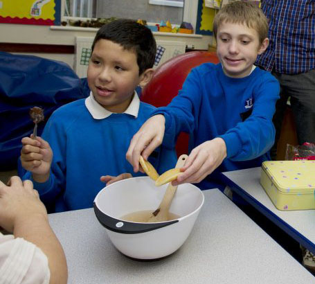 Boy with teacher cooking