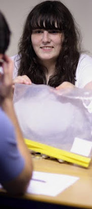 Teacher showing a zip bag to a child