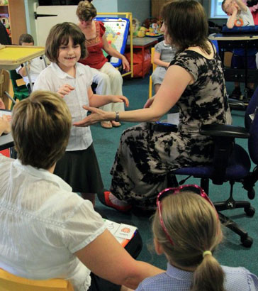 Teacher holding a boy's hand