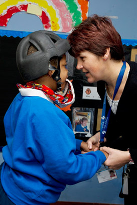 Teacher holding a boy's hands