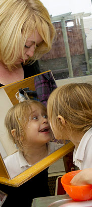 Girl smiling in front of a mirror