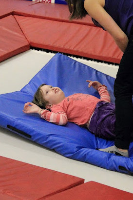 Girl on a trampoline with a teacher