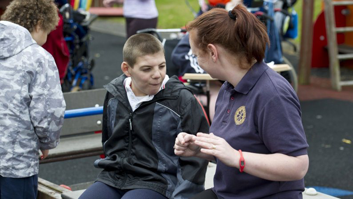 A teacher communicating with
a boy