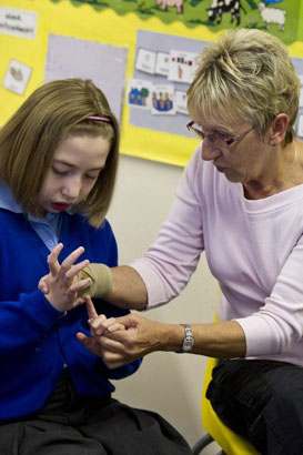 teacher with boy at front of class