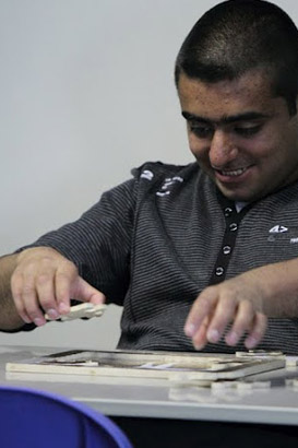 Boy putting together a puzle.