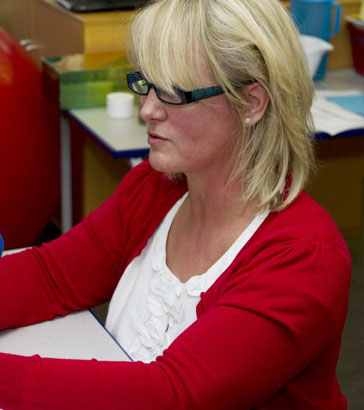 A teacher analyses data using a personal
                  computer