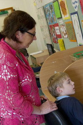 teacher with boy at front of class